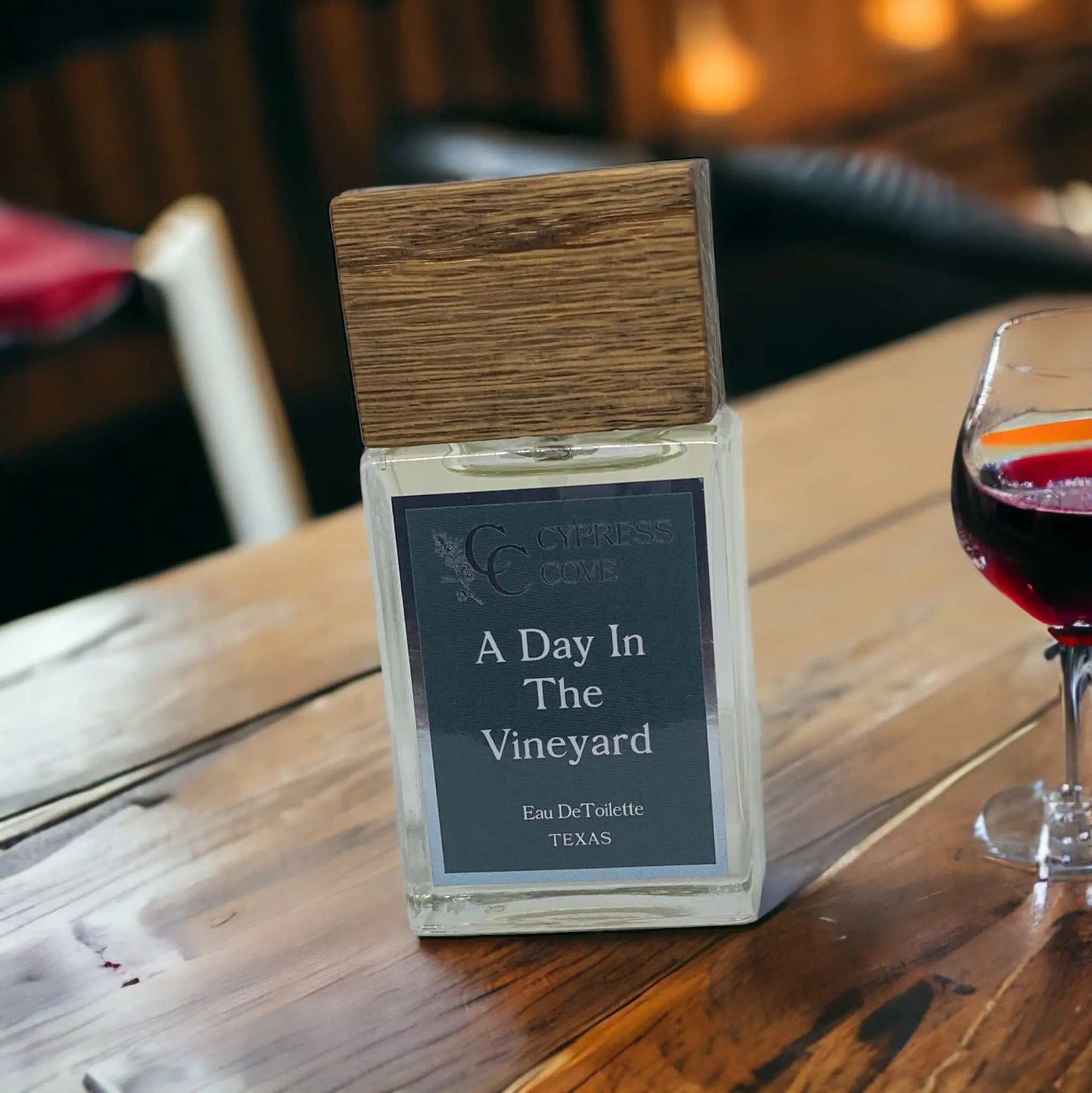 Bottle of vineyard-inspired perfume with citrus, lavender, and woody notes, handcrafted by Cypress Cove.