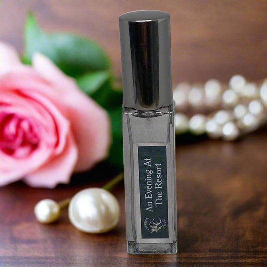 Small perfume bottle labeled 'An Evening At The Resort' on a gray background